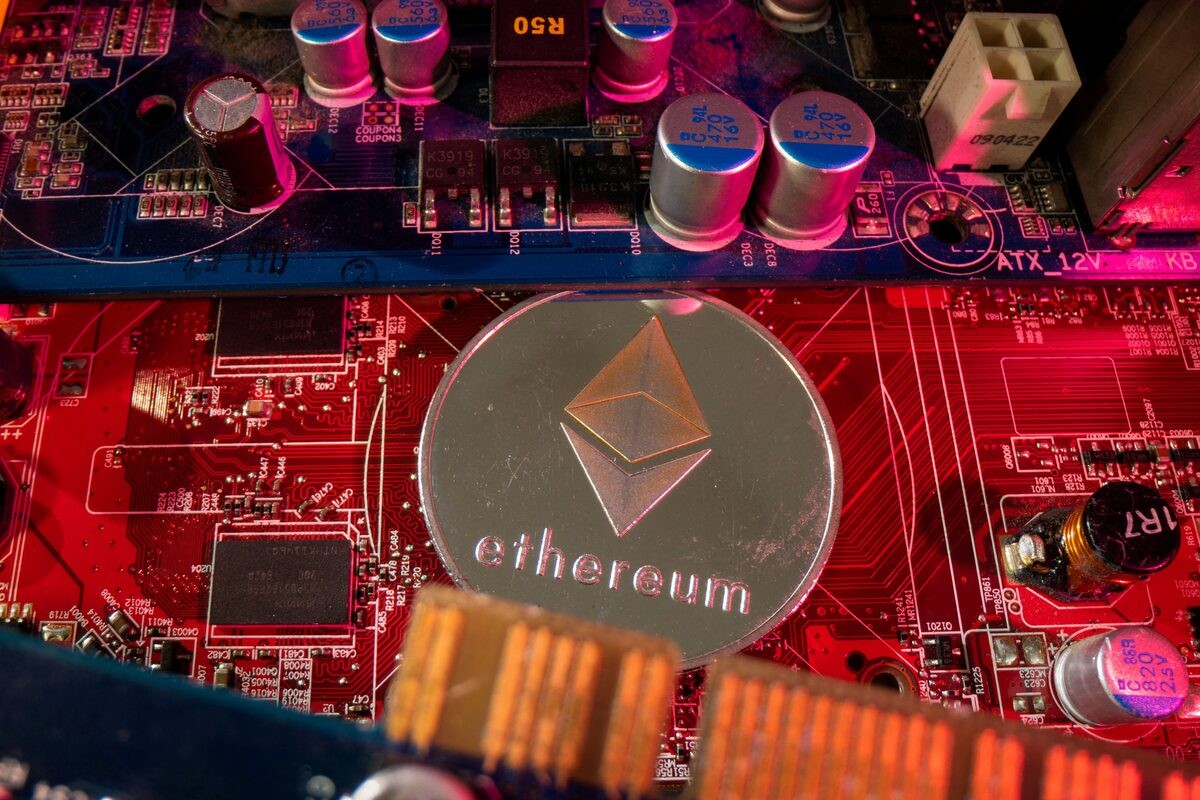Ethereum logo is visible on a red and blue circuit board motherboard. Ethereum logo is visible on a red and blue circuit board motherboard.