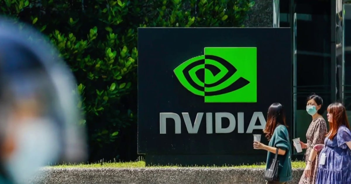 NVIDIA logo sign visible outdoors; three masked women walk past holding cups.