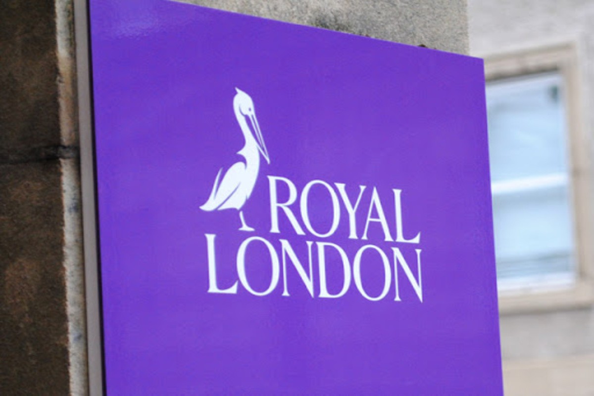 A purple "ROYAL LONDON" sign with a bird logo is mounted on a stone building exterior. A purple "ROYAL LONDON" sign with a bird logo is mounted on a stone building exterior.