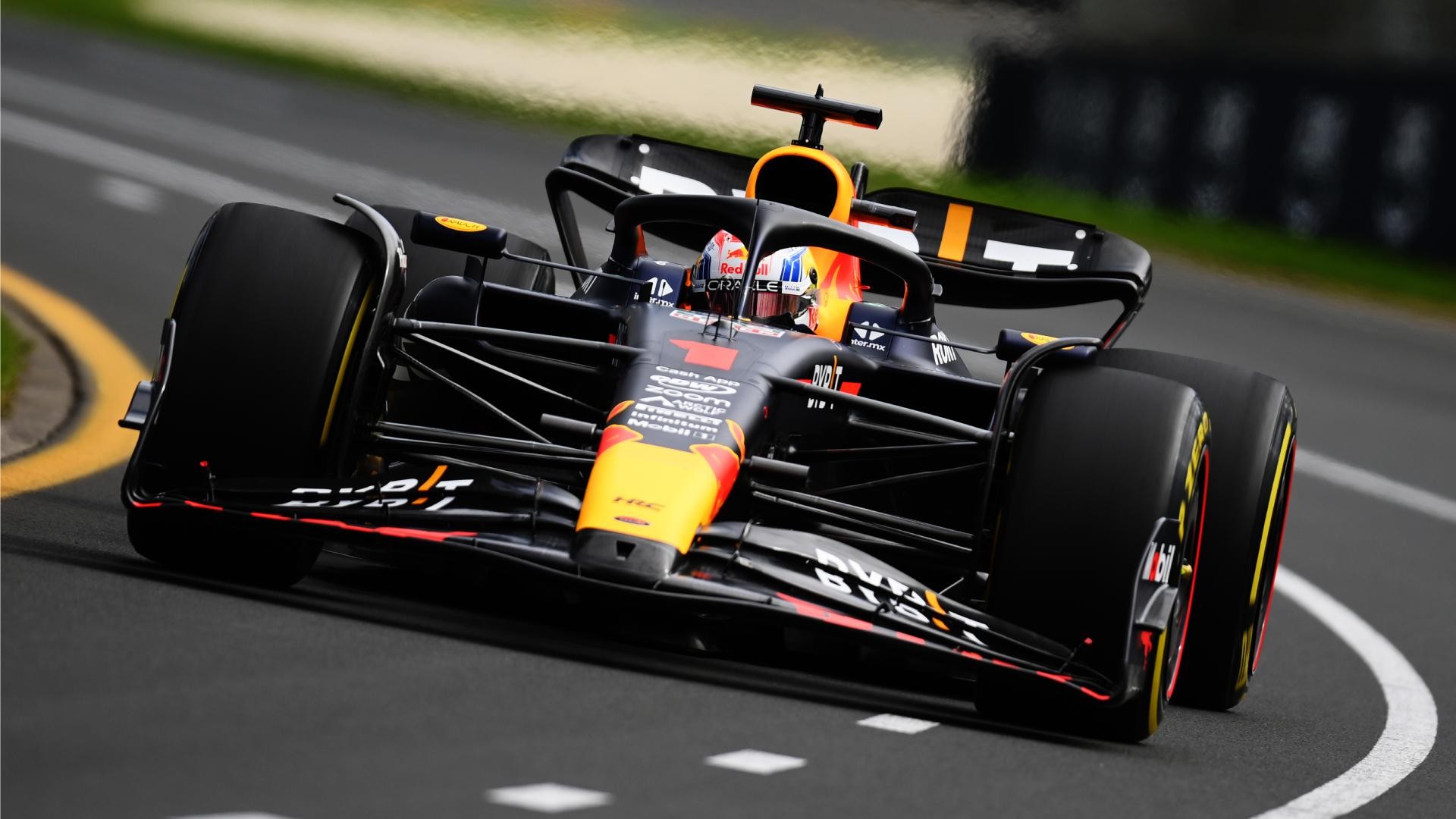 A Formula 1 race car navigates a curved racetrack during a race. A Formula 1 race car navigates a curved racetrack during a race.