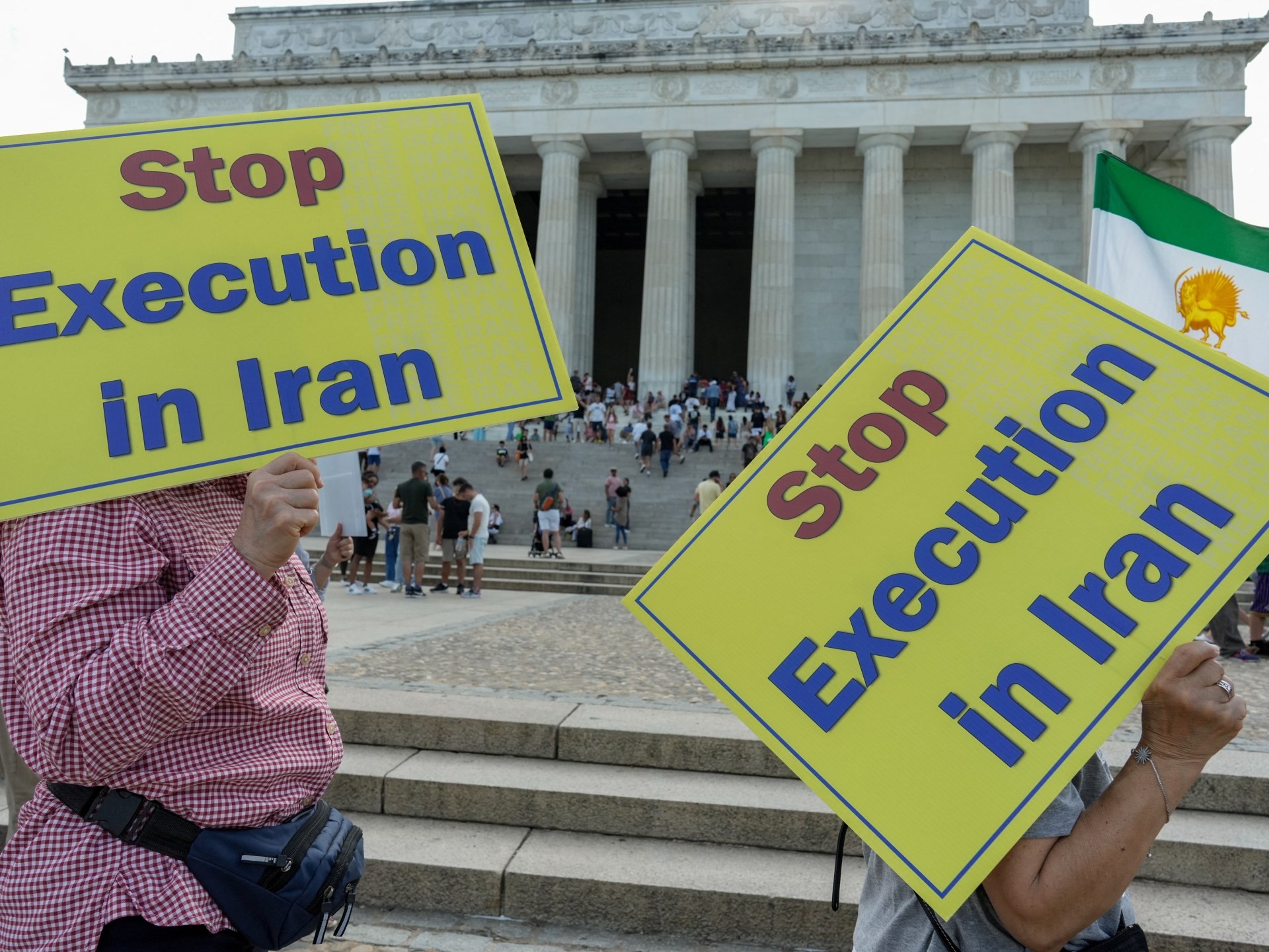 Protesters hold "Stop Execution in Iran" signs at Lincoln Memorial steps. Protesters hold "Stop Execution in Iran" signs at Lincoln Memorial steps.