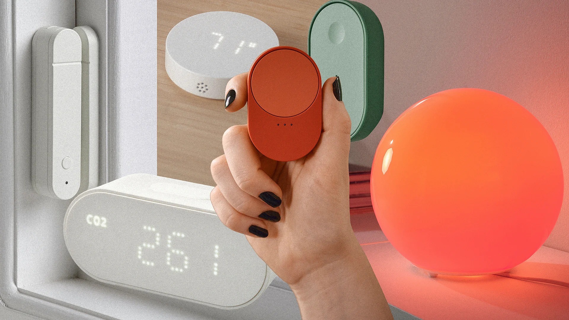 Hand holds orange smart device amid CO2 monitor, door sensor, and glowing orb in smart home setting. Hand holds orange smart device amid CO2 monitor, door sensor, and glowing orb in smart home setting.