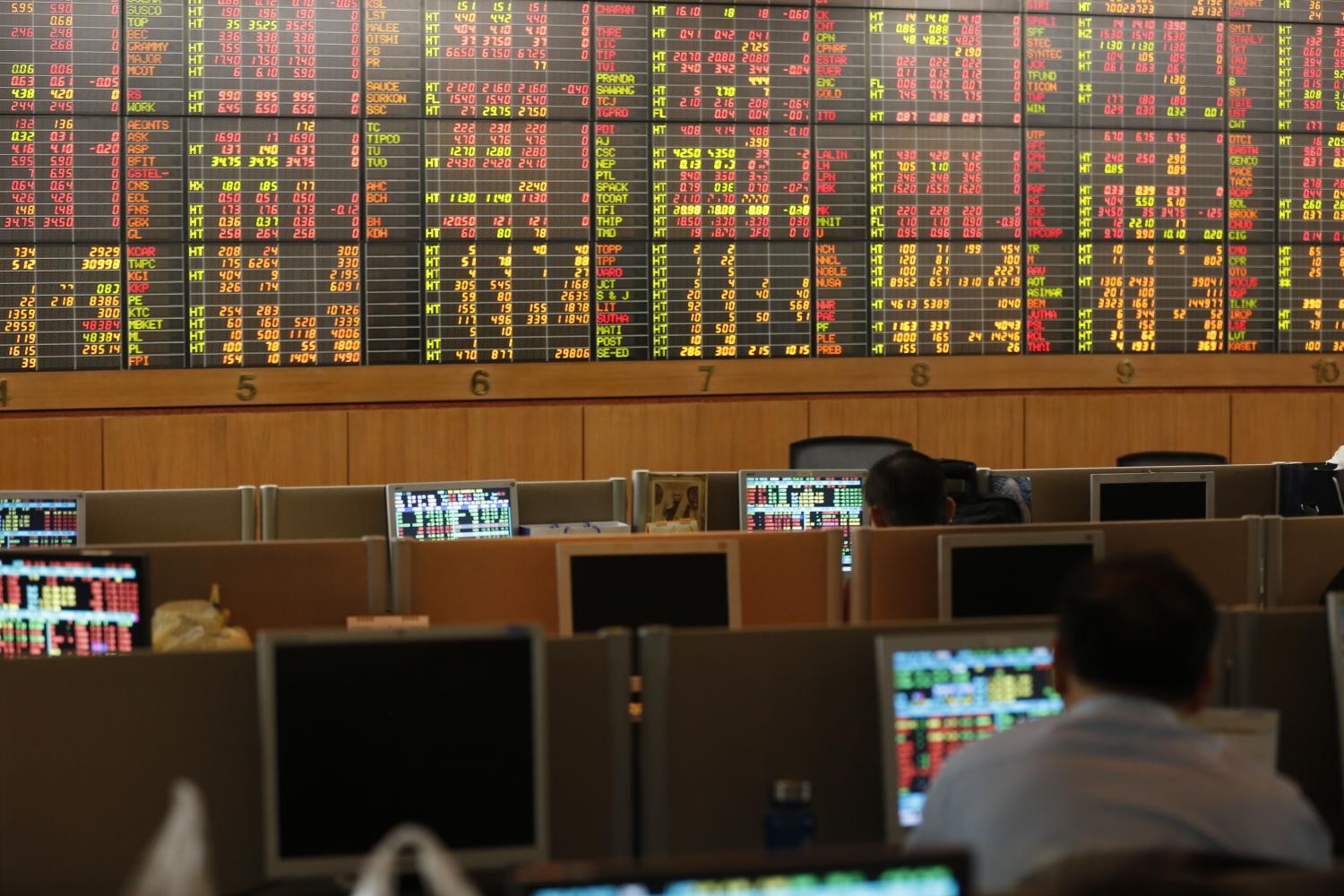 Traders monitor market data on computer screens in a stock exchange trading room. Traders monitor market data on computer screens in a stock exchange trading room.