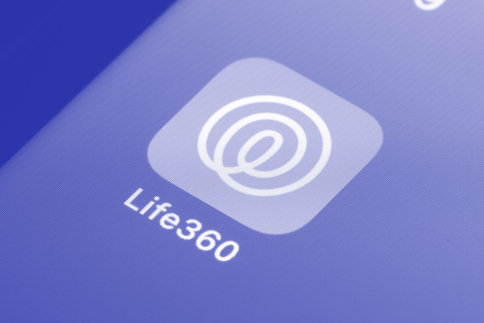 Life360 app icon displayed on a smartphone screen with blue gradient background. Life360 app icon displayed on a smartphone screen with blue gradient background.