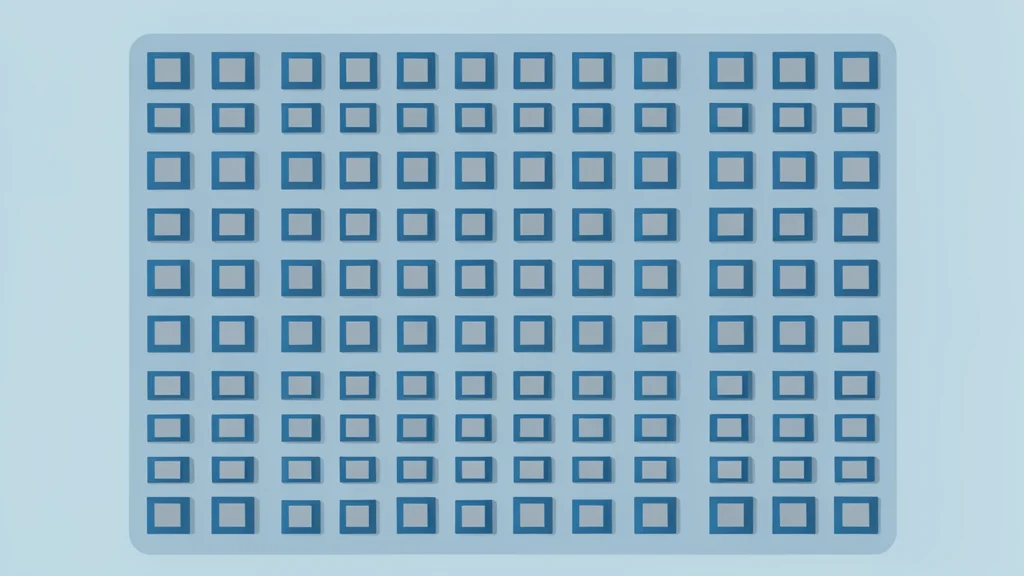 A close-up view of a silicon wafer with a grid of square integrated circuits