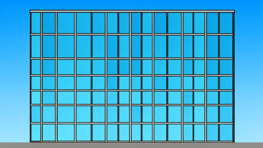 A modern glass office building with a grid of windows reflecting the sky
