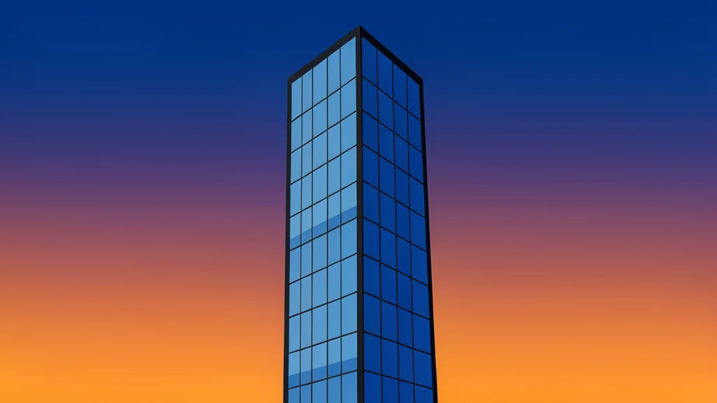 A modern glass skyscraper reflecting the twilight sky