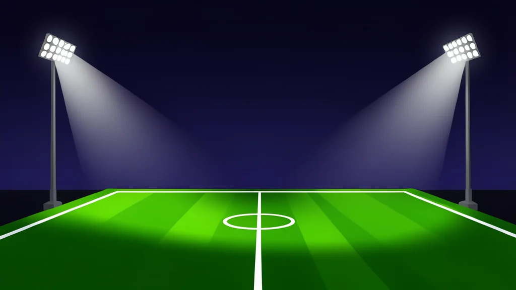 A grassy football field stretching under bright stadium lights at night, with no players or scoreboards, emphasizing the empty pitch and atmospheric glow.