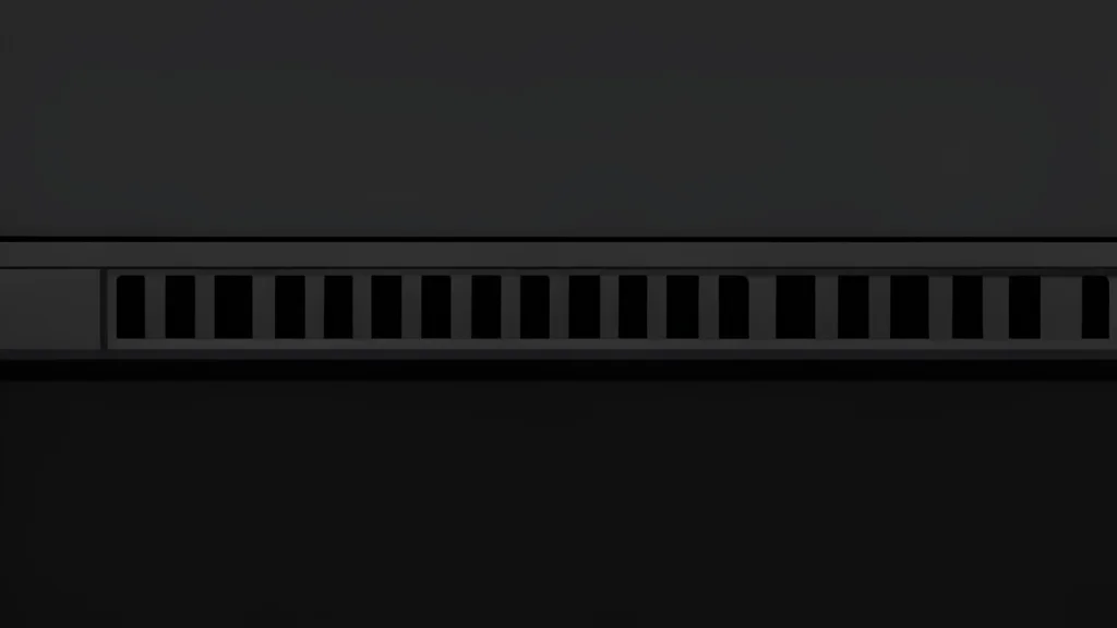 A sleek black laptop with a glowing geometric light strip along the front edge resting on a dark surface.