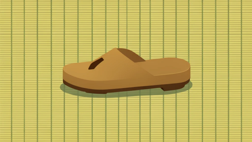 A traditional Japanese wooden geta sandal resting on a tatami mat