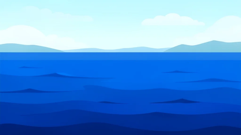 A vast expanse of deep blue sea water with gentle waves, stretching towards a distant, hazy coastline under a bright sky.