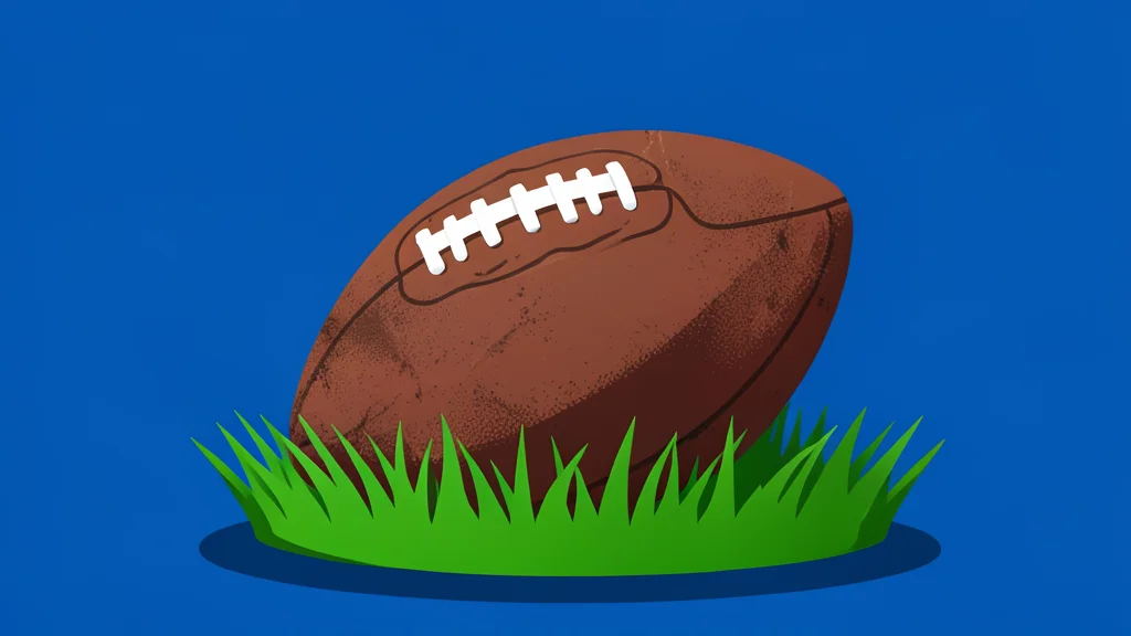 A worn brown leather football resting on vibrant green grass