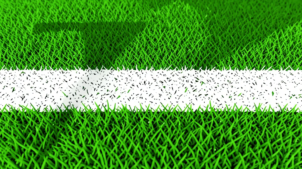 A football field with white yard lines and goalposts in the distance