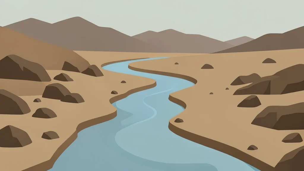 A winding river flowing through a dry, rocky landscape with distant mountains in the background.