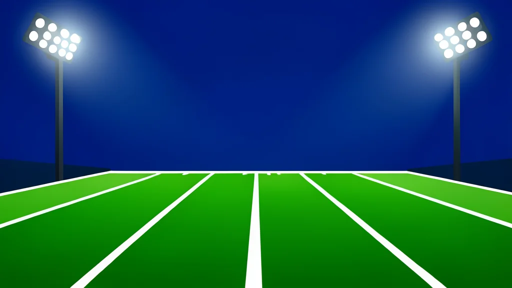 A green football field with white yard lines stretching into the distance under bright stadium lights
