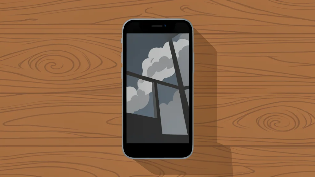 A solitary smartphone resting on a wooden desk, screen off, reflecting a window view of a cloudy sky