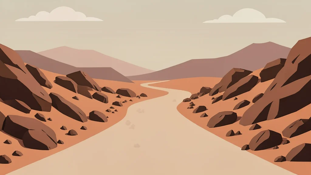 A dusty, unpaved road winding through arid, rocky terrain under a hazy sky