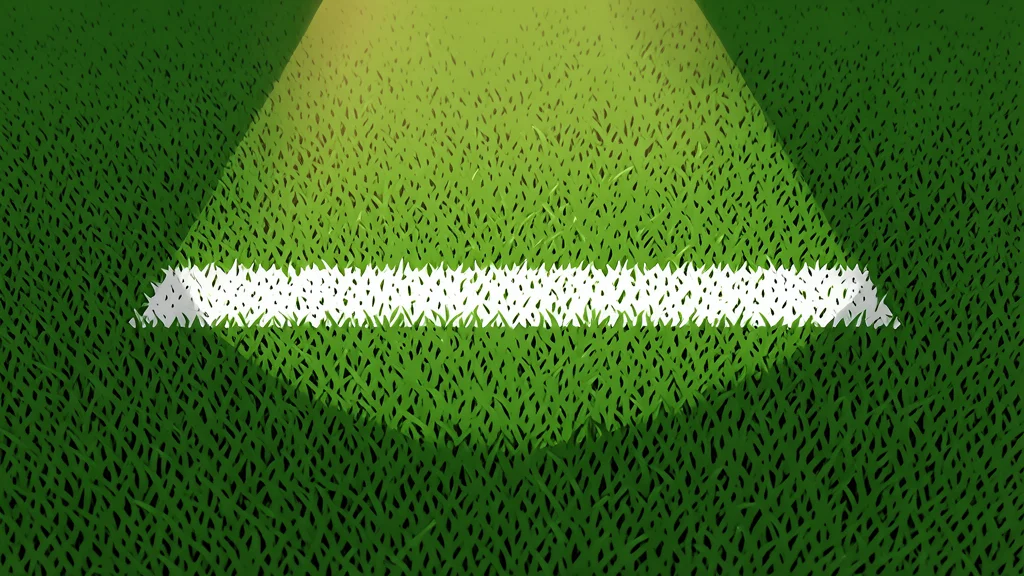 A modern football stadium with green turf and white yard lines under bright stadium lights