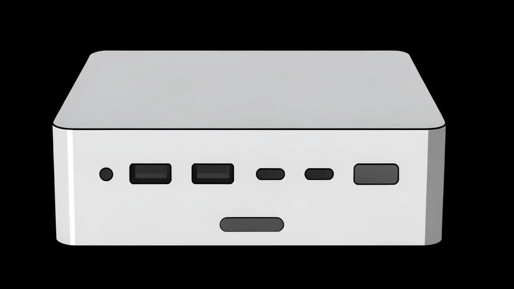 A small, rectangular black computer box sitting on a wooden desk next to a keyboard