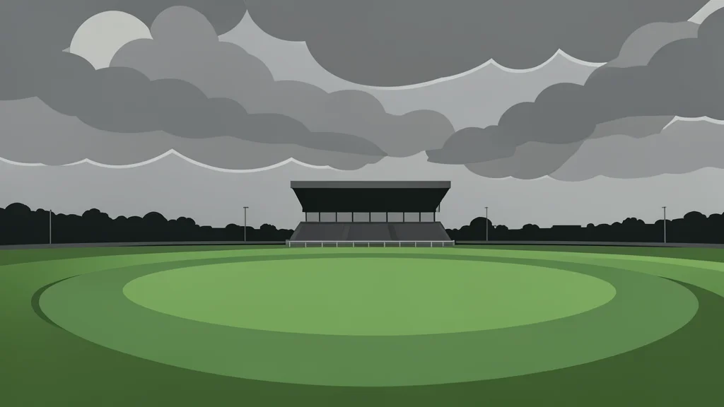 A grassy racecourse track curving around a distant grandstand under a cloudy sky