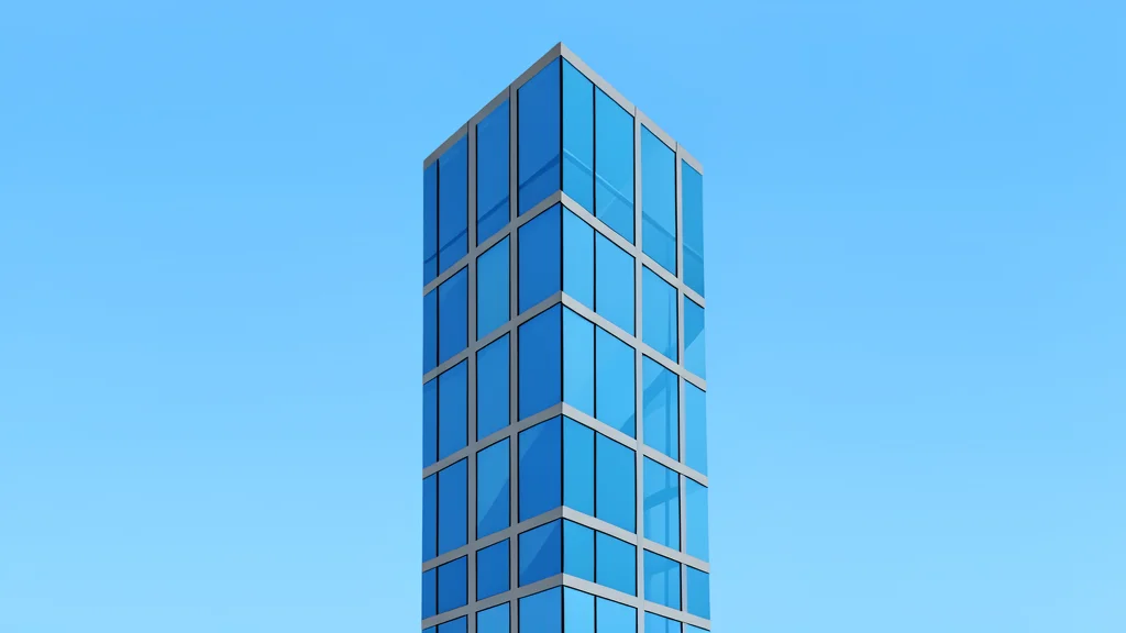 A modern glass skyscraper facade reflecting a calm blue sky