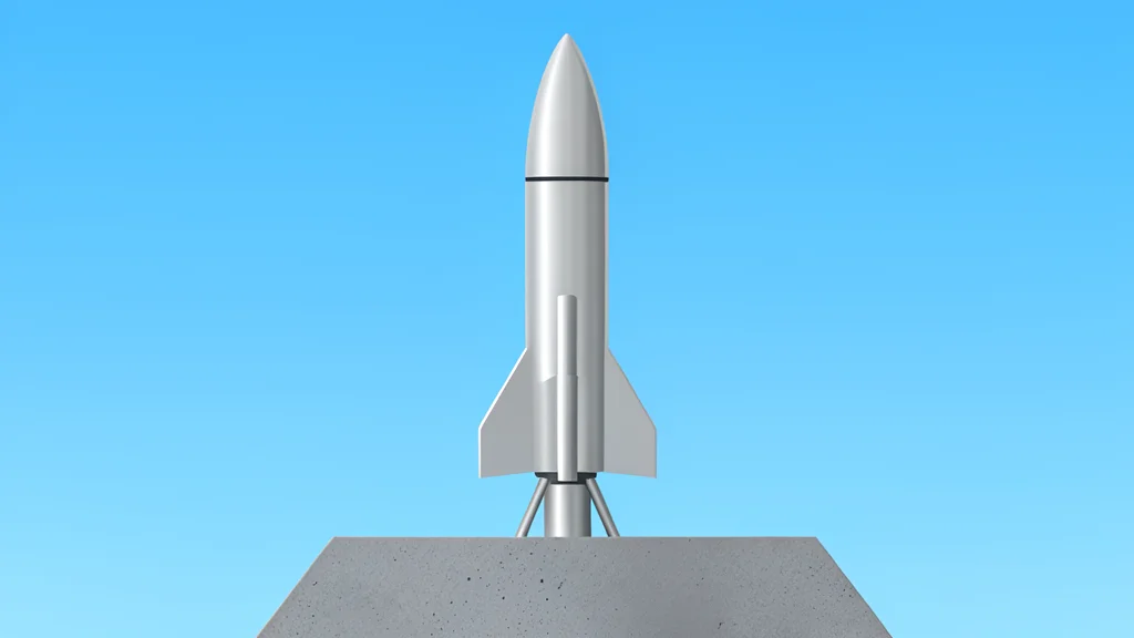 A sleek, metallic rocket standing vertically on a concrete launch pad against a clear blue sky
