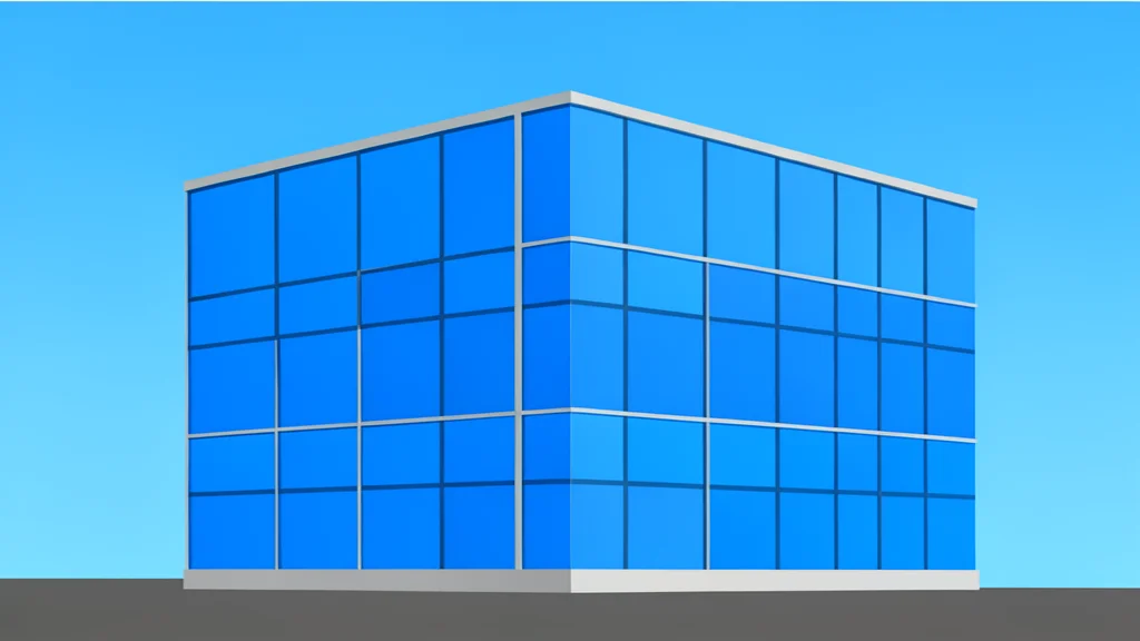 A modern glass office building facade reflecting a clear blue sky