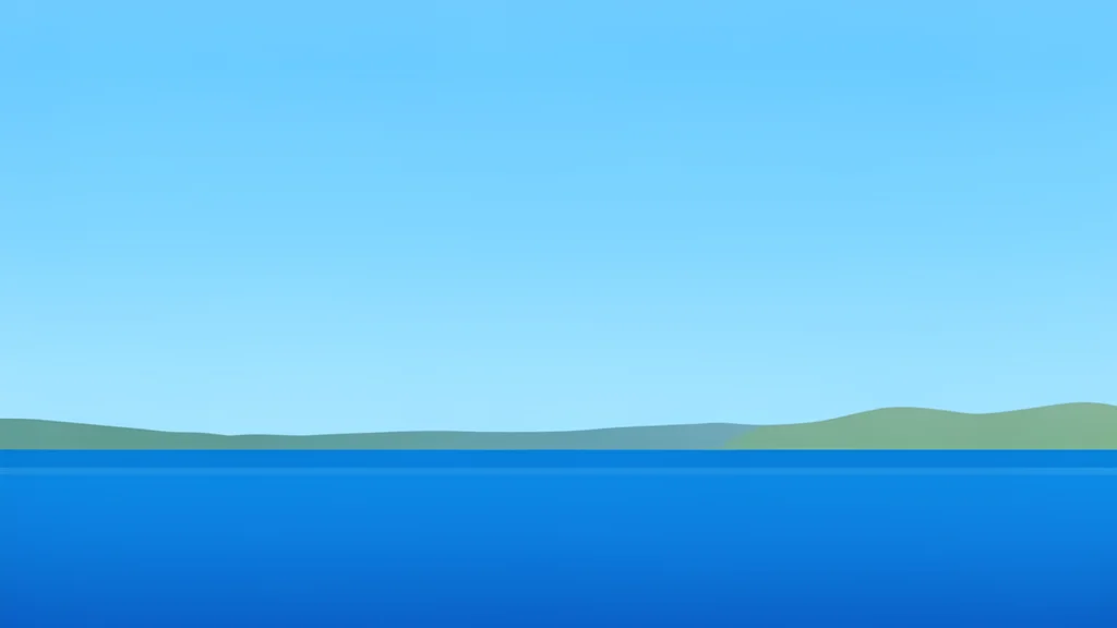 A calm stretch of ocean water meeting a distant coastline under a clear sky