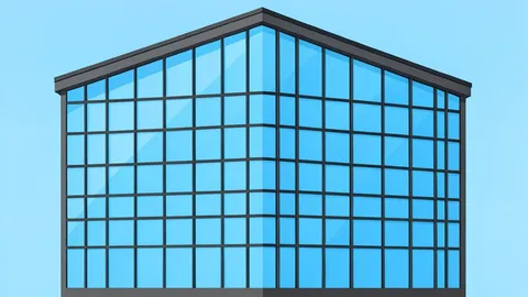 A modern glass office building with a grid of windows reflecting the sky