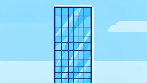 A modern glass skyscraper with a grid of windows reflecting the sky