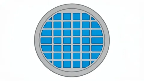 A close-up view of a silicon wafer with a grid of square chips