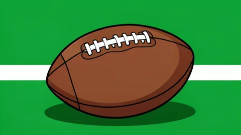 A green football field with white yard lines and a brown leather football resting on the grass
