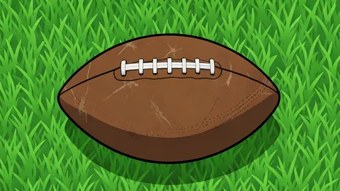 A worn leather football resting on green artificial turf