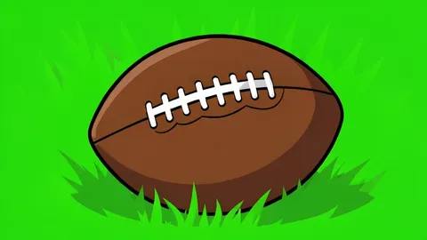 A football resting on the green grass of a stadium field