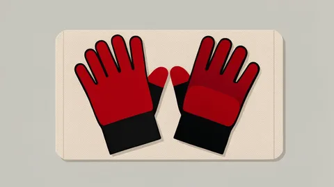 A pair of red and black padded gloves resting on a canvas mat