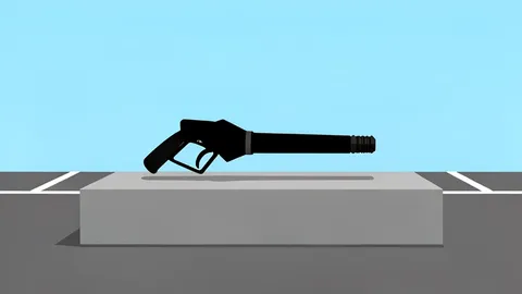 A solitary gas pump nozzle resting on a concrete island in a parking lot.