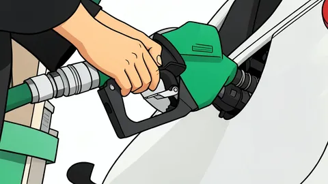 A gas pump nozzle resting on a concrete forecourt