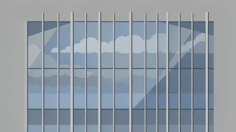 A modern glass office building facade reflecting a cloudy sky