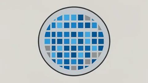 A close-up view of a silicon wafer featuring a precise grid of square chips.