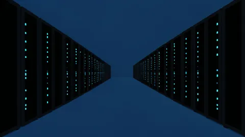 A vast, dimly lit server room with rows of black rectangular units featuring glowing blue status lights