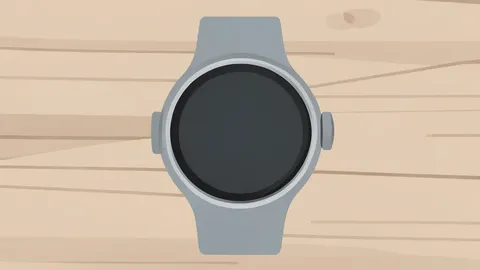 A modern smartwatch with a round face and a rotating crown resting on a wooden surface