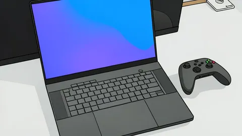 A slim, dark-colored laptop with a glowing keyboard resting on a wooden desk