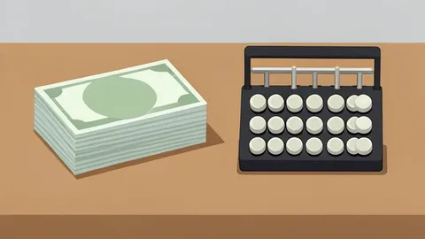 A stack of paper currency and a mechanical abacus resting on a wooden desk surface