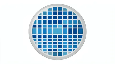 A close-up view of a silicon wafer with a grid of square chips