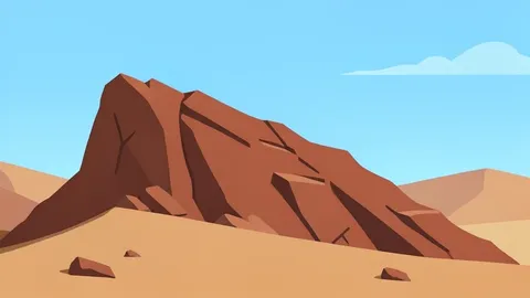 A rugged, reddish-brown rocky outcrop in a dry, arid landscape under a bright sky