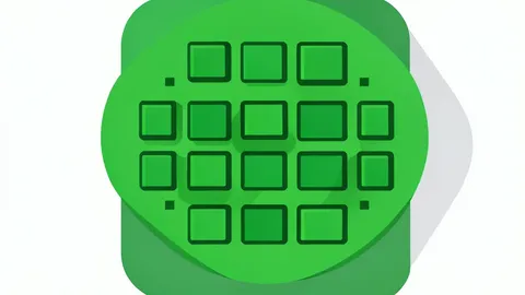 A close-up of a green silicon wafer with a grid of square chips