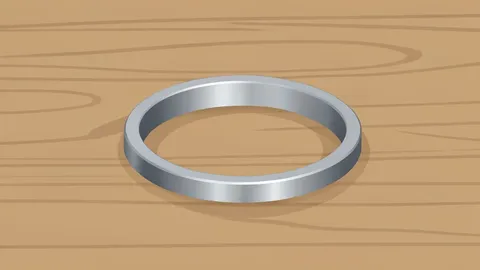 A small, smooth titanium band resting on a wooden surface