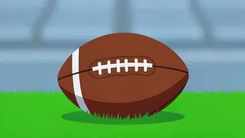 A football resting on the green grass of a stadium field