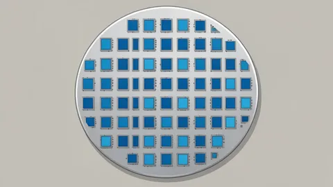 A close-up view of a silicon wafer with a grid of square chips
