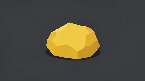 A rough nugget of gold resting on a dark surface